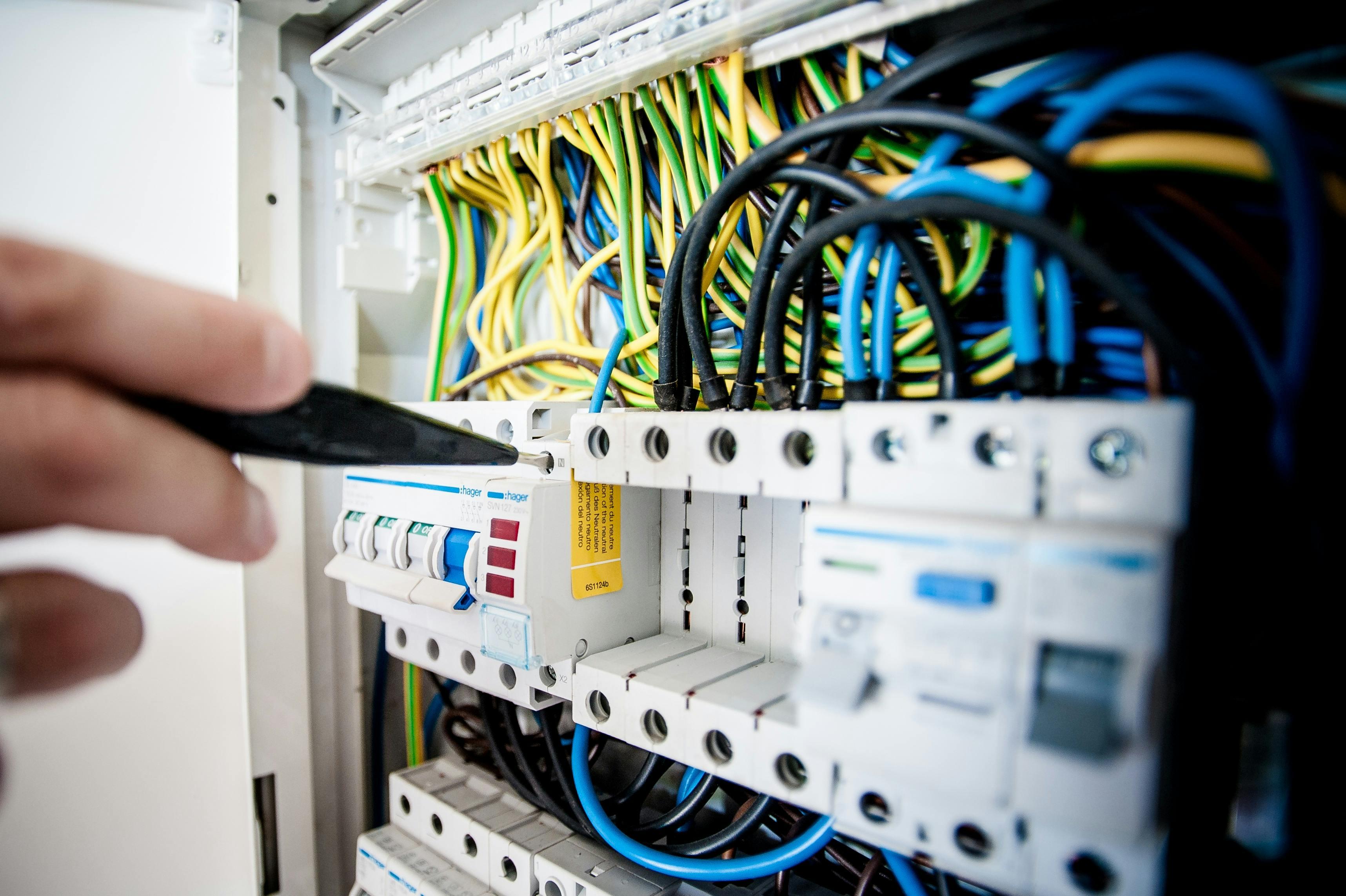 Electrician inspecting electrical work in a home